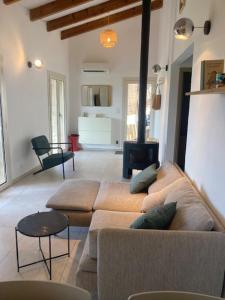 a living room with a couch and a stove at Dolce e Lumiu in Lumio