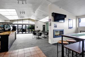 an office with a fireplace and tables and chairs at Kaponga Hotel in Kaponga