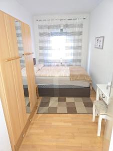 a small bedroom with a bed and a window at Apartments bei Marienplatz in Stuttgart +7 photos