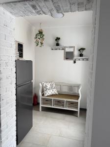 a kitchen with a refrigerator and a bench in a room at Ferienwohnung Kurze Auszeit 24 Std Check in in Hesel +14 photos