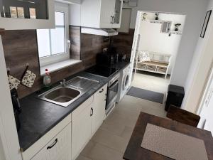 a small kitchen with a sink and a stove at Ferienwohnung Kurze Auszeit 24 Std Check in in Hesel
