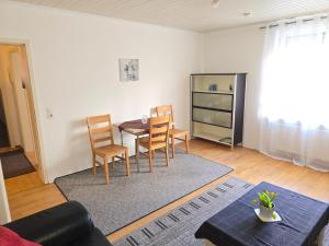 a living room with a dining room table and chairs at Apartments bei Marienplatz in Stuttgart
