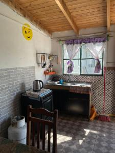 a kitchen with a stove and a smiley face on the wall at Inactivo in Chuy