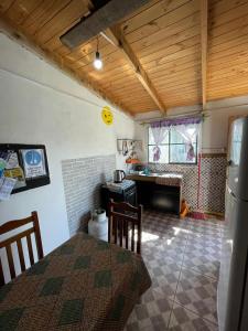a kitchen with a table and a desk in a room at Inactivo in Chuy