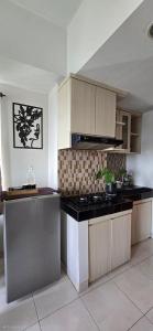a kitchen with a stove and a counter top at Soft Reset Room by YOMAIN in Kemirimuka Tiga +6 photos