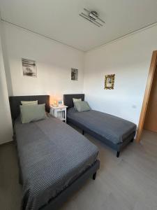 a bedroom with two beds and a table with a lamp at Oliva Sol Apartment in Oliva +10 photos