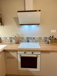 a kitchen with a counter with a stove top oven at le Roy de coeur in Riquewihr