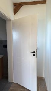 a sliding door in a room with a white wall at Ranczo pod dębami in Wola Smolana
