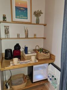 a room with a wooden table with baskets on it at Escale à Kergrenn in Fouesnant +6 photos