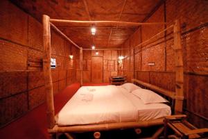 a bedroom with a bed in a room at Bali Bamboo Resort in Padinjarathara
