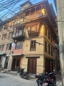 a building with two motorcycles parked in front of it at the locals bhaktapur in Bhaktapur