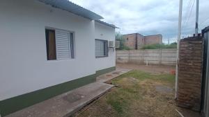a side view of a white house with a window at Los Pinos de Horizonte in Fernández