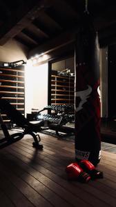a person holding a snowboard in a gym at Hotel Tsanteleina in Val-d'Isère