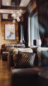 a living room with couches and a chandelier at Hotel Tsanteleina in Val-d'Isère