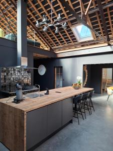 a kitchen with a wooden counter top in a room at L'entrepôt Spadois in Spa