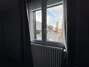 a window with a view of a building at Hôtel - Restaurant Eugenie in Pontorson