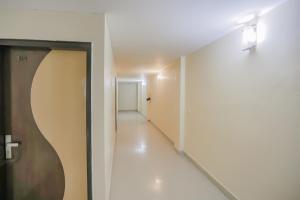 an empty hallway with a door and a hallway leading to a room at Collection O Green Park Residency 3 in New Delhi