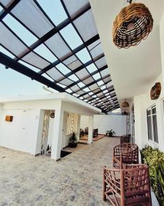 a lobby with a ceiling with skylights and chairs at Baru chachalacas in Chachalacas