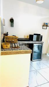 a kitchen with a counter with a stove top oven at Baru chachalacas in Chachalacas