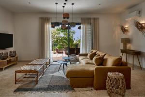 a living room with a couch and a table at Yokan Lodge in Palmarin