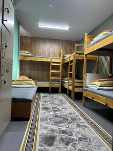 a room with four bunk beds and a rug at DelLuna in Almaty