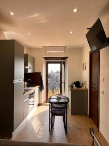 a kitchen with a table and a small table at La Casetta in Grotte di Castro