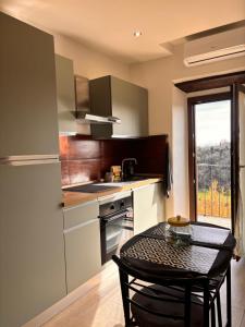 a small kitchen with a table and a window at La Casetta in Grotte di Castro