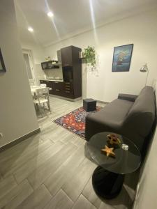 a living room with a couch and a table at La Suite del Borgo in Bovalino Marina