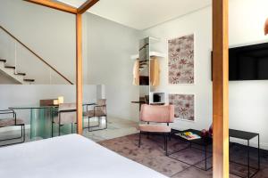 a bedroom with a bed and a table and chairs at Palazzo Sovrana Serviced Luxury Apartments in Palermo