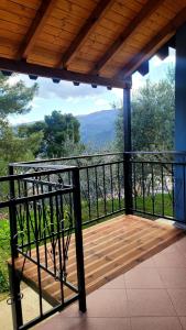 a porch with a wooden deck with a view at Rama Guest House in Berat