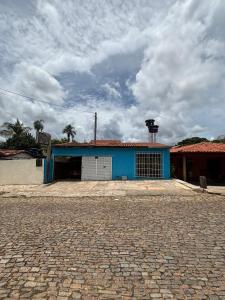 a blue building with a weather vein on top of it at Pouso do Carmo in Pirenópolis