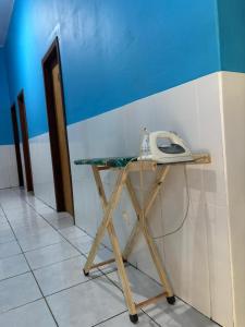 a desk with a phone sitting on top of it at Pouso do Carmo in Pirenópolis