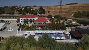 a large building with a pool in front of it at Pensiunea Lebada in Tulcea
