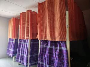 a row of colorful curtains in a room at Sunny in town hostel in Pai