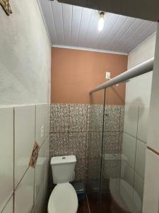 a bathroom with a toilet and a shower at Pouso do Carmo in Pirenópolis +6 photos