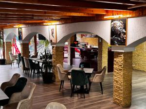a restaurant with tables and chairs and a bar at Pensiunea Lebada in Tulcea