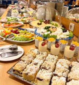a table filled with plates of food and appetizers at Hotel Nordkap in Karlshagen