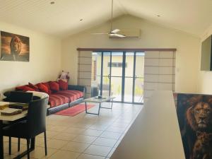 a living room with a couch and a table at Boyne island beach house in Boyne Island
