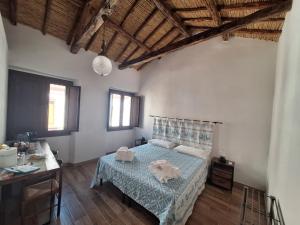 a bedroom with a bed with two towels on it at Dommu Amsicora Piano 2 in Baunei