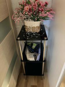 a small table with a basket of flowers on it at Ivory & Rose Studio in Tartu