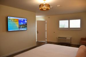a living room with a flat screen tv on the wall at Inn at the Waterpark in Galveston