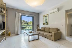 a living room with a couch and a table at G.Living 365 in Agia Effimia