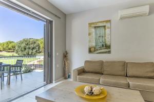 a living room with a couch and a table at G.Living 365 in Agia Effimia