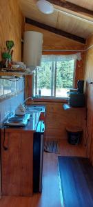 a kitchen with a stove and a counter top at Cabañas Entre Mañios y Coigües in Villa Santa Lucía