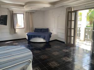 a room with a blue table and a window at A passos do paraíso!! in Lauro de Freitas +40 photos