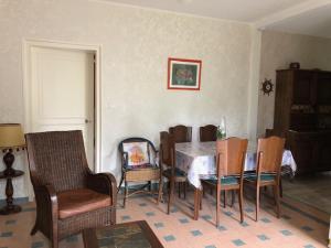 a dining room with a table and chairs at le logis des Chabannes in Saint-Angel