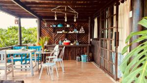 an outdoor patio with a table and chairs at Nhà Bên Hồ in Bảo Lộc