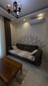 a couch sitting in a living room with a table at Serenity Residence apartment in Alanya +21 photos