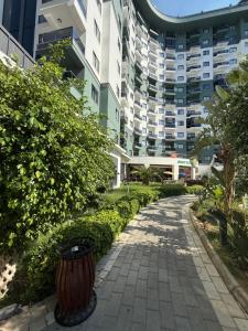 a sidewalk in front of a building with a trash can at Serenity Residence in Alanya