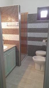 a bathroom with a toilet and a sink at Casa Grazia Deledda 16 in Orosei